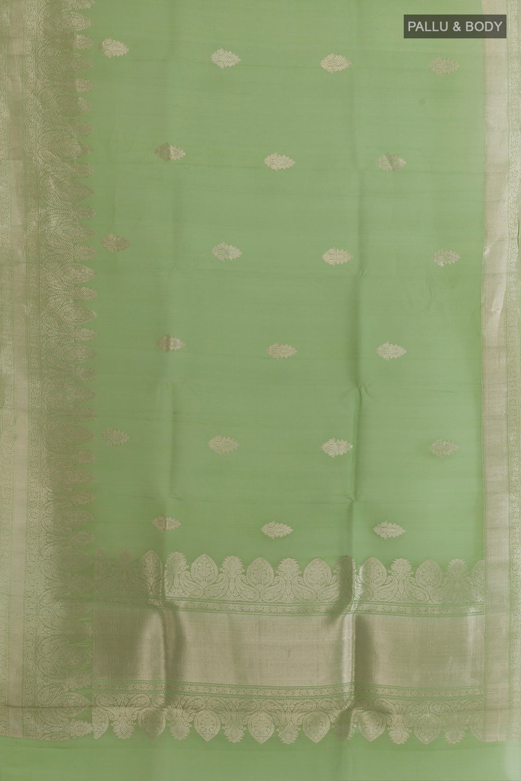 Flat view of Pista Green Organza Saree with Zari Butta on the body and Zari Border. 