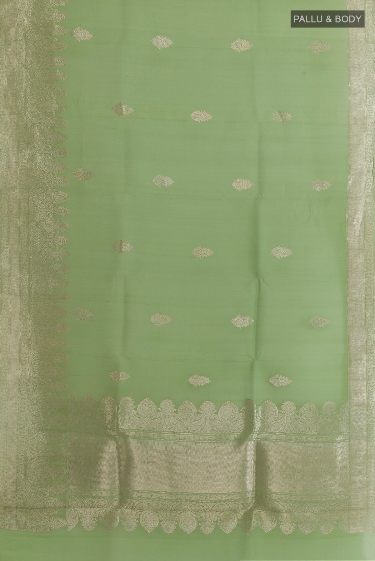 Flat view of Pista Green Organza Saree with Zari Butta on the body and Zari Border. 
