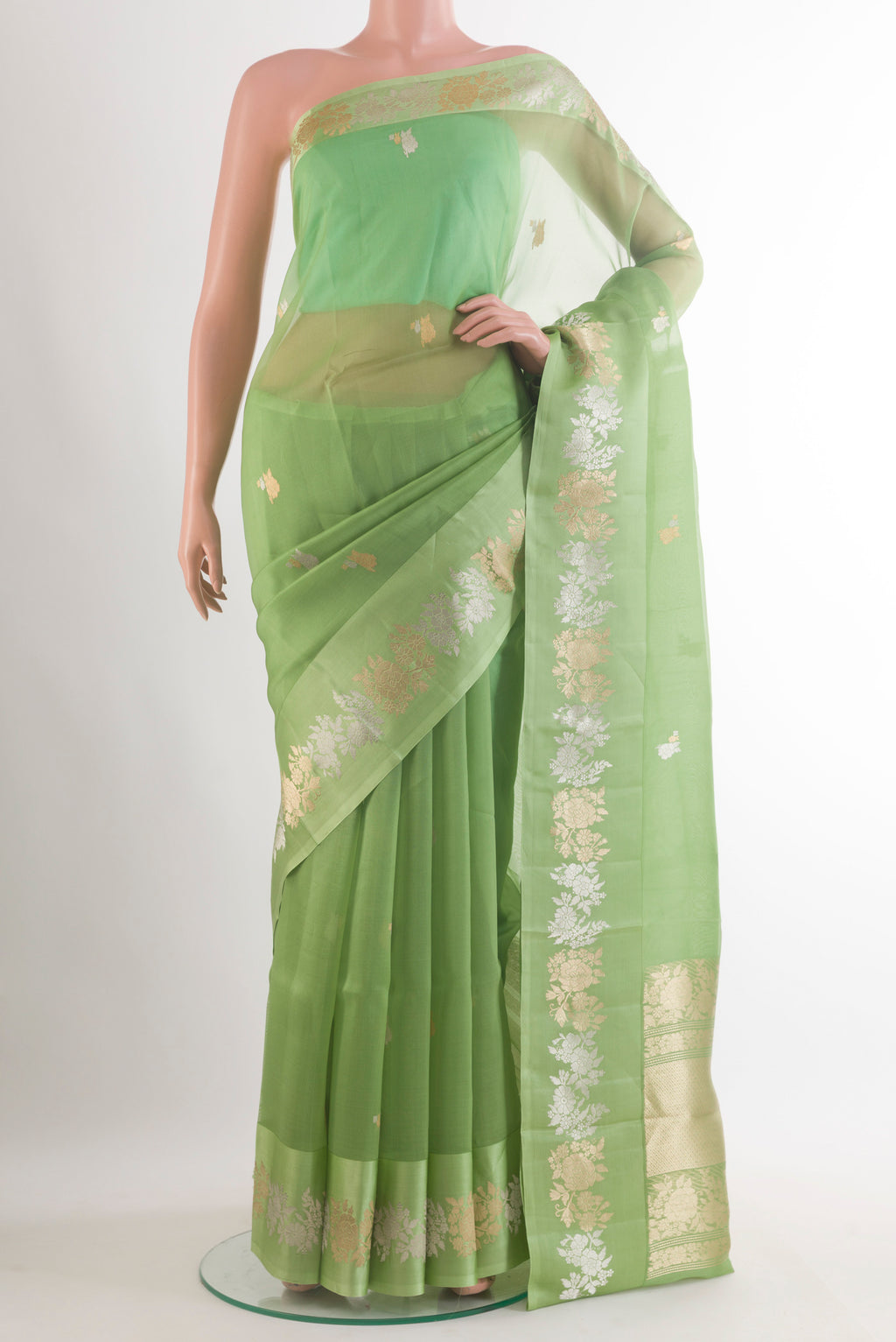 Pista Green Organza Saree with Zari Butta on the body and Zari Border.  displayed on a mannequin