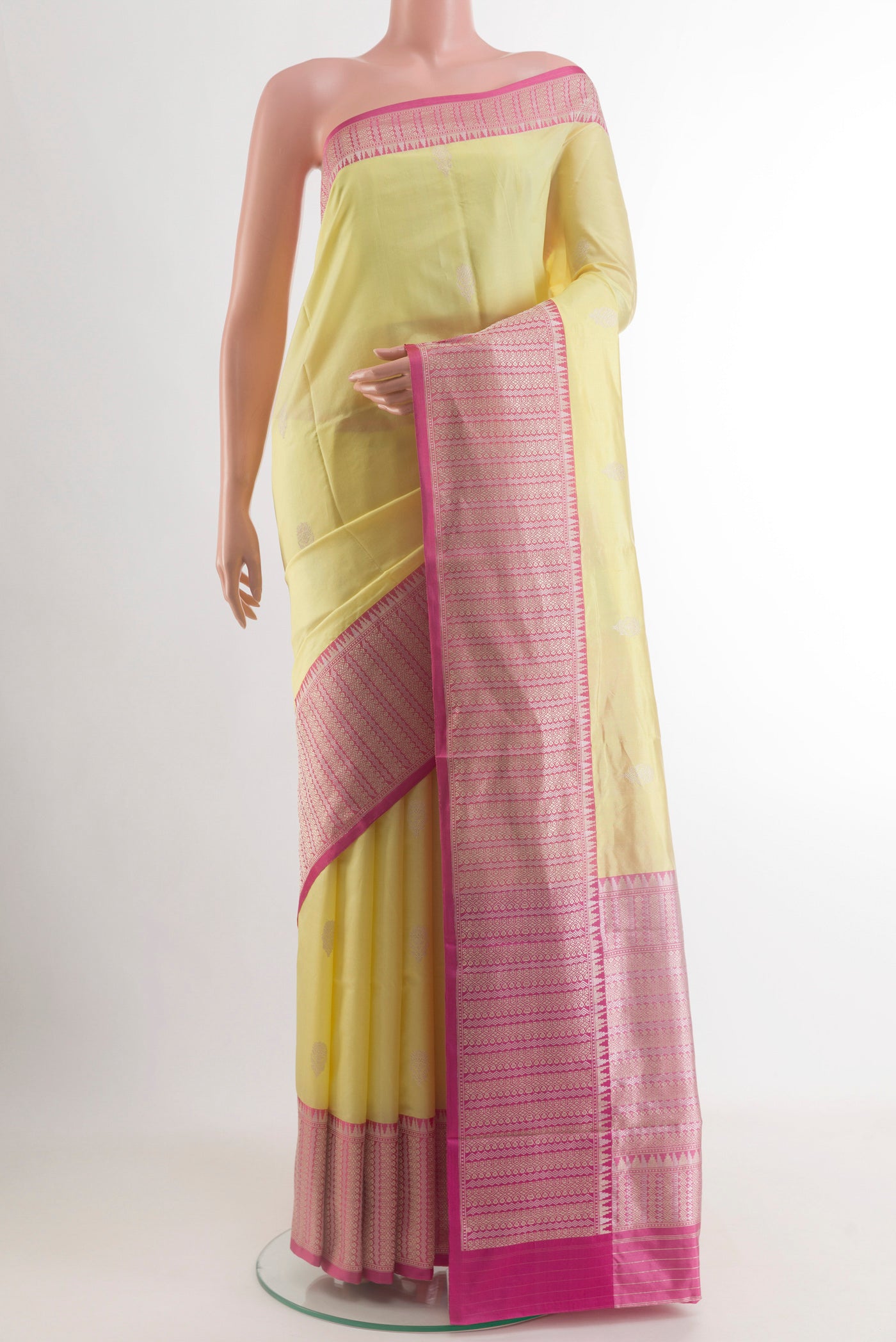 Lemon Yellow Banarasi Katan Silk Saree with Zari Butta on the body and Zari Border.  displayed on a mannequin