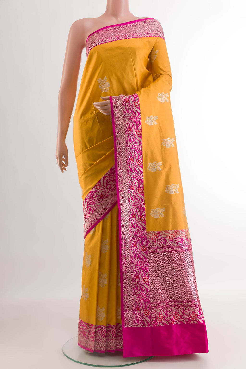 Yellow Banarasi Katan Silk Saree with Zari Butta on the body and Zari Border.  displayed on a mannequin
