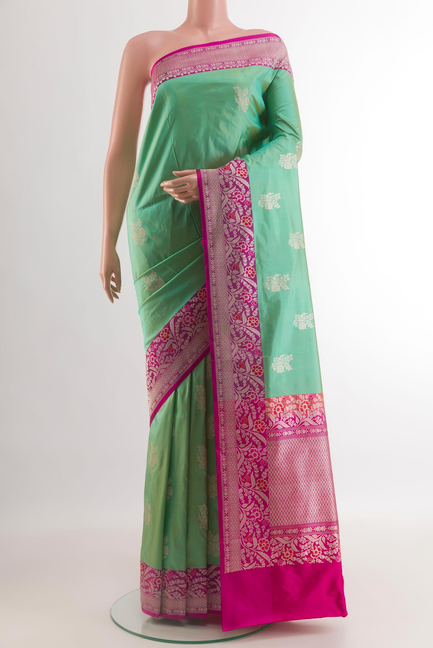 Sea Green Banarasi Katan Silk Saree with Zari Butta on the body and Zari Border.  displayed on a mannequin