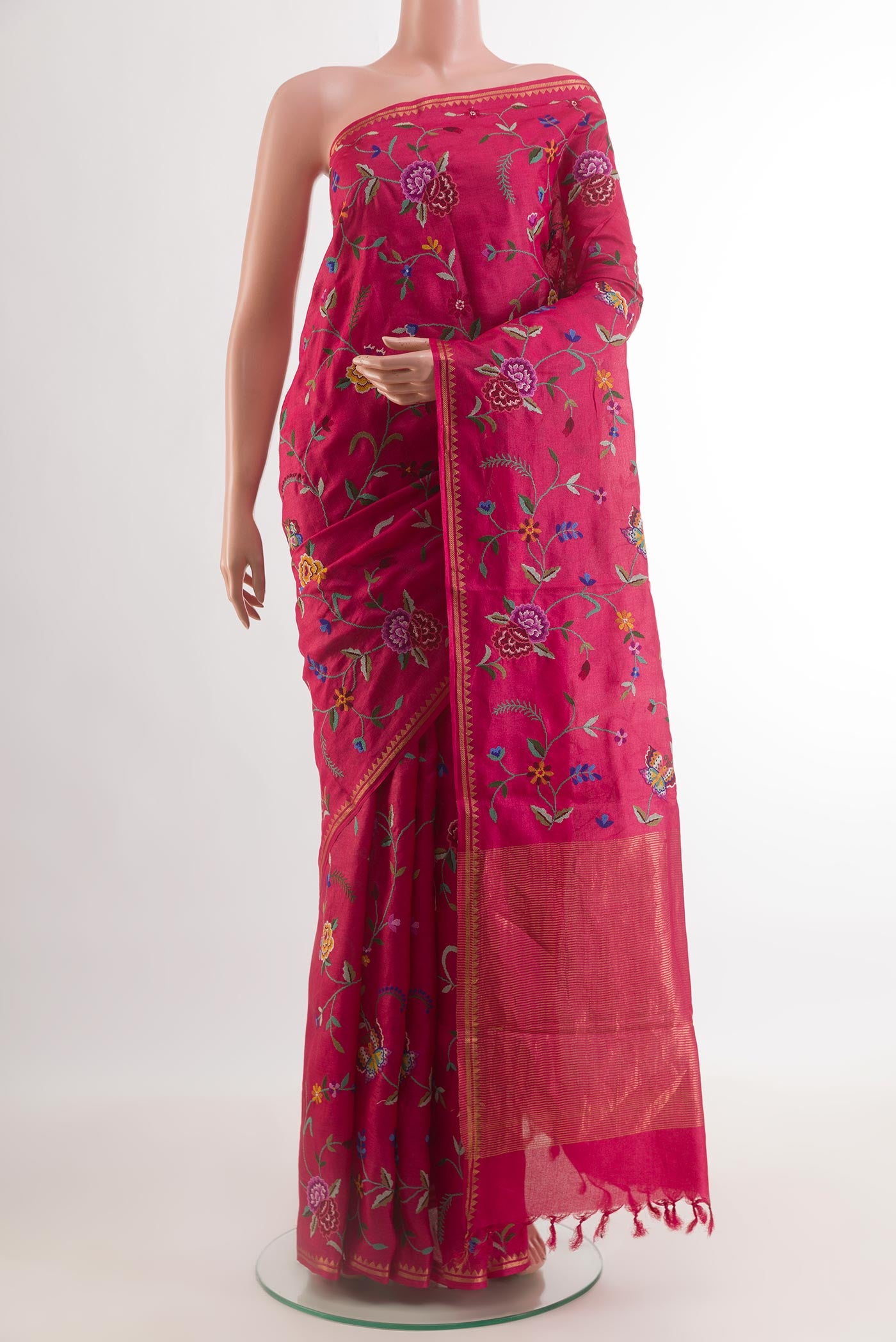 Pink Tussar Silk Saree with Embroidery on the body and Zari Border.  displayed on a mannequin