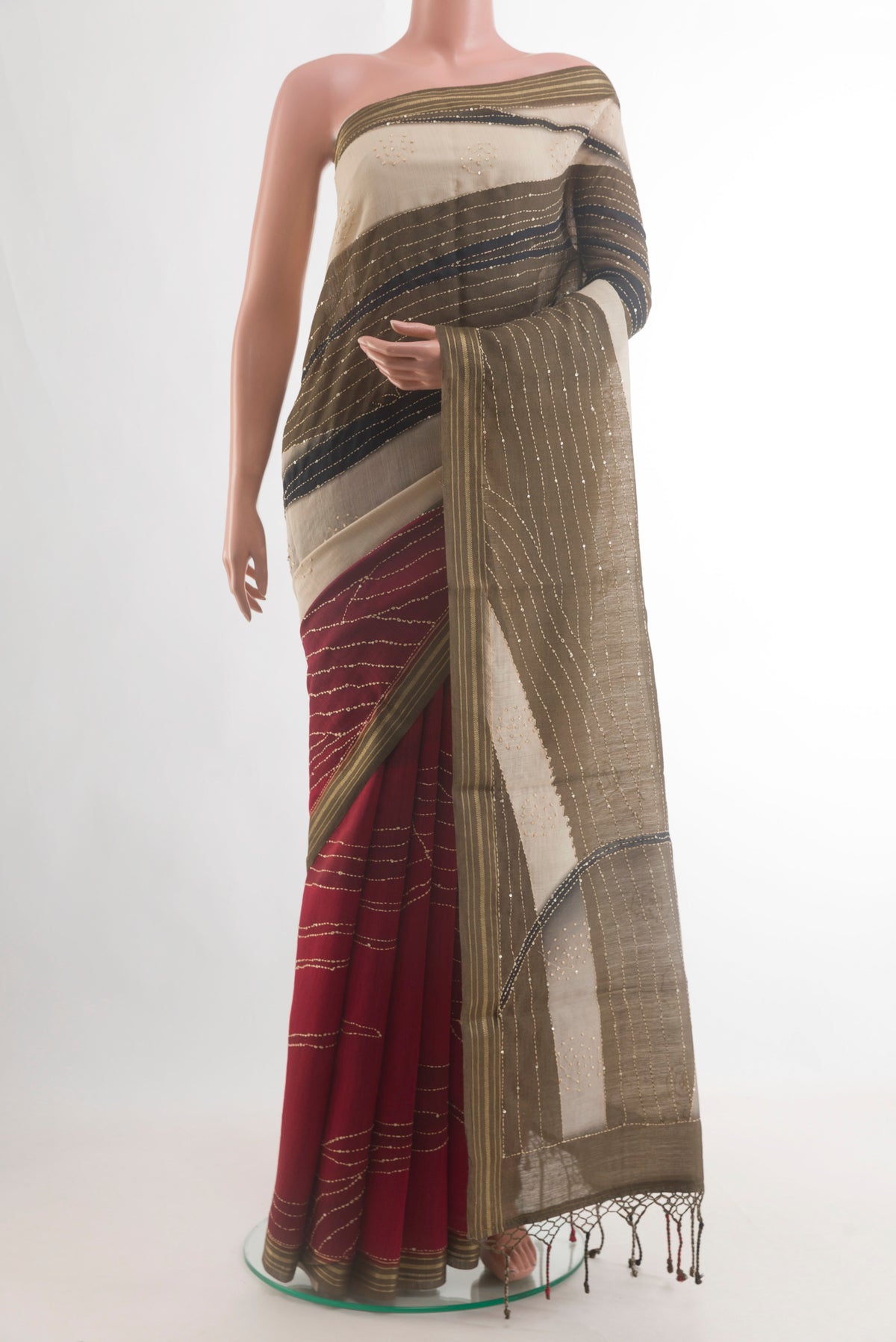 Beige Tussar Saree with Embroidery on the body and Zari Border.  displayed on a mannequin