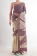 Off White Tussar Saree with Printed design on the body and Zari Border.  displayed on a mannequin