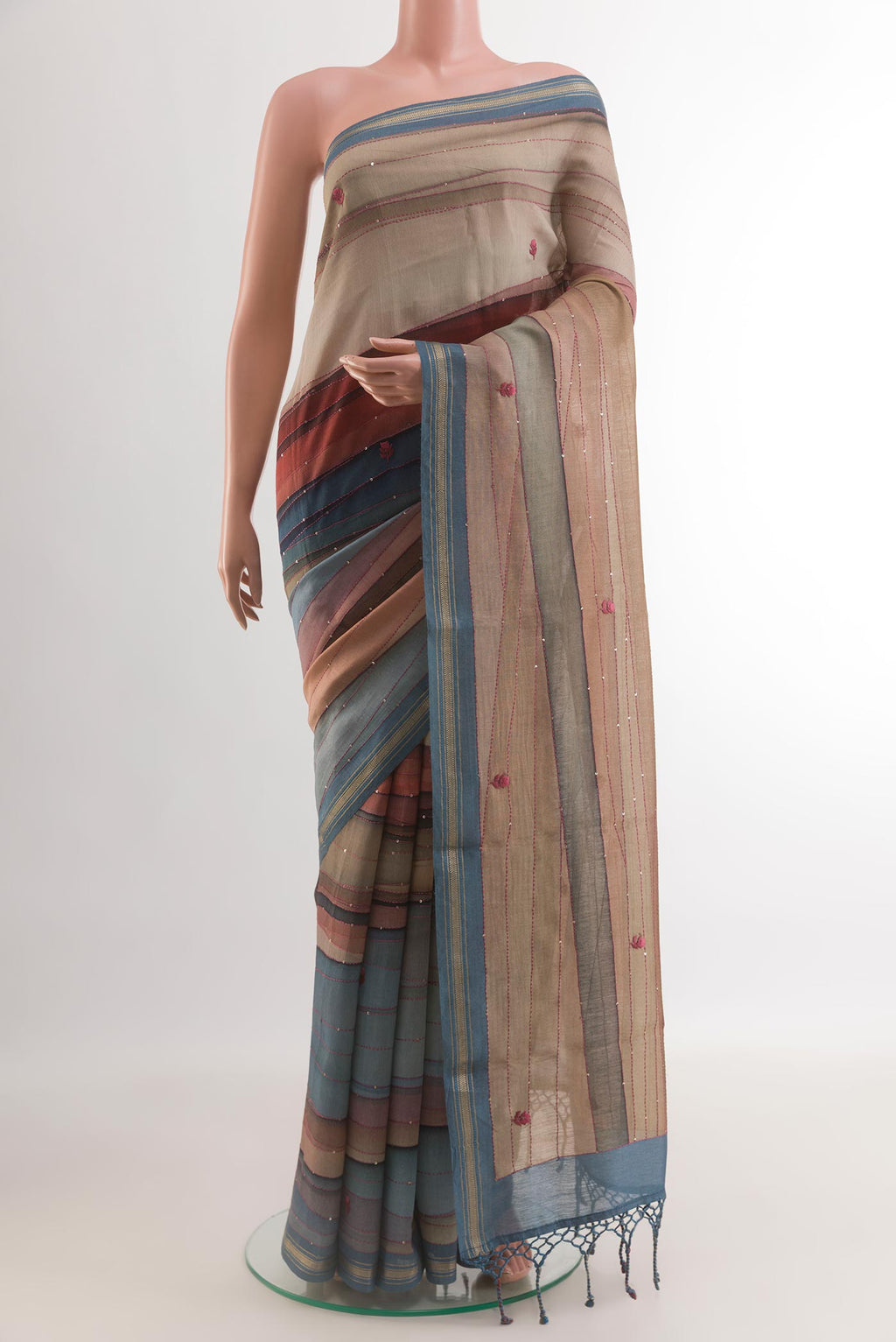 Multi Color Tussar Silk Saree with Embroidery on the body and Zari Border.  displayed on a mannequin