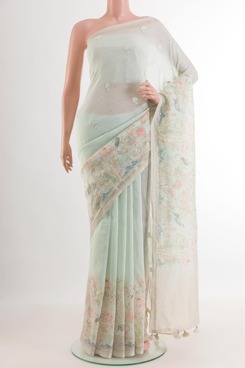 Light Blue Linen Saree with Embroidery on the body and Zari Border.  displayed on a mannequin