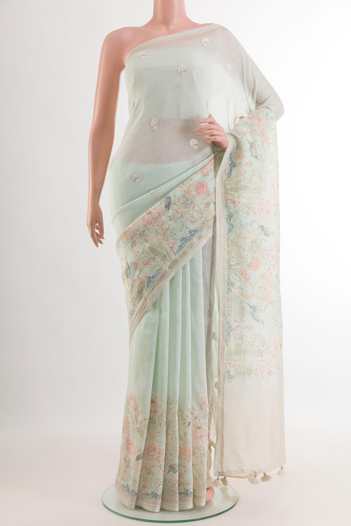 Light Blue Linen Saree with Embroidery on the body and Zari Border.  displayed on a mannequin