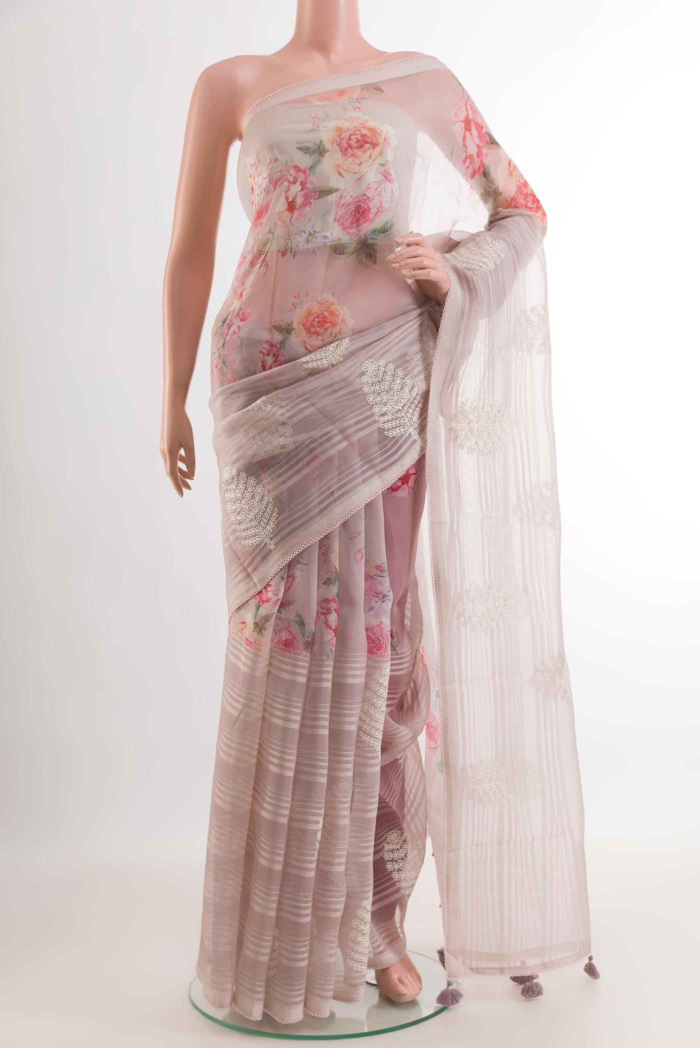 Lavender Organza Silk Saree with Floral Print on the body and Embroidery Border.  displayed on a mannequin