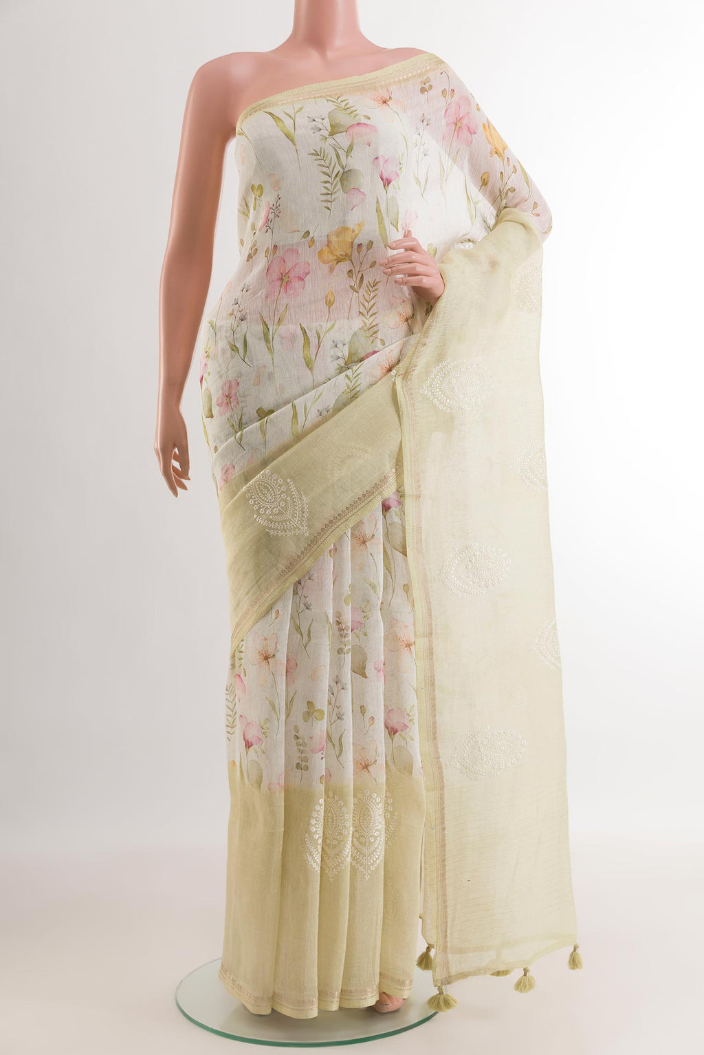Off White Linen Saree with Floral Print on the body and Zari Border.  displayed on a mannequin