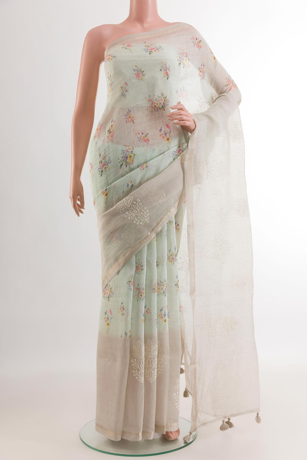 Off White Linen Saree with Floral Print on the body and Zari Border.  displayed on a mannequin