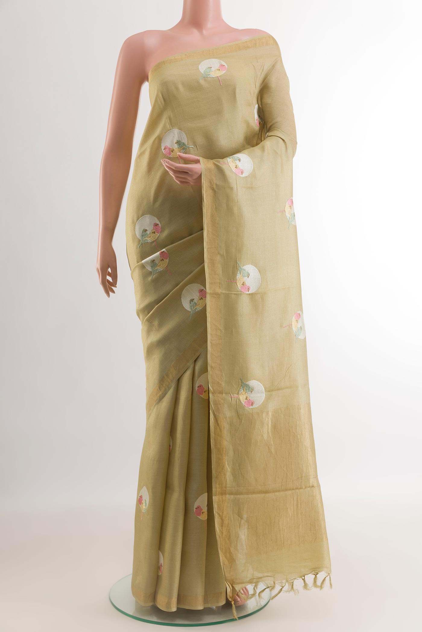 Beige Tussar Silk Saree with Printed design on the body and Zari Border.  displayed on a mannequin