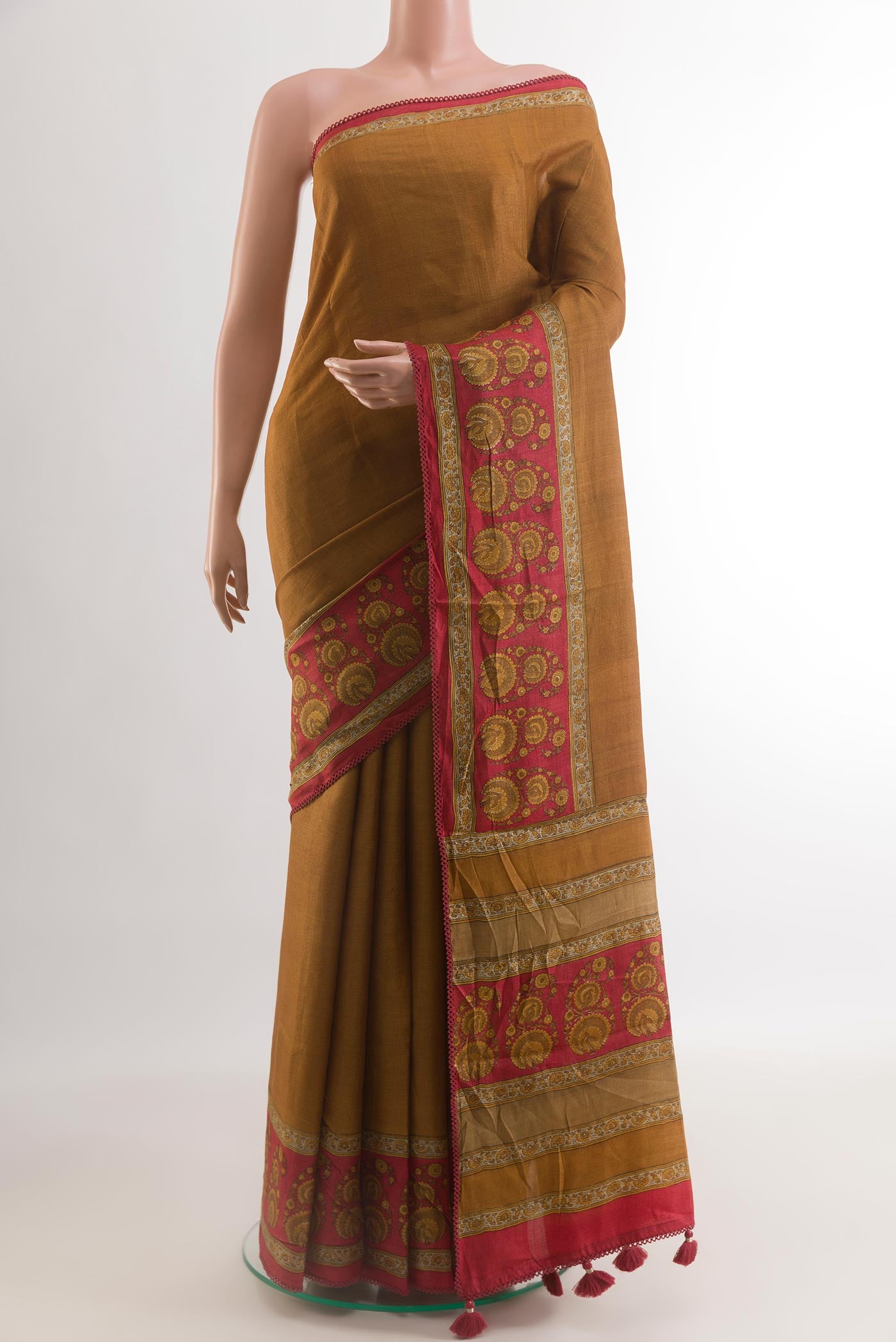 Mustard Tussar Silk Saree with Plain Body and Printed Border.  displayed on a mannequin