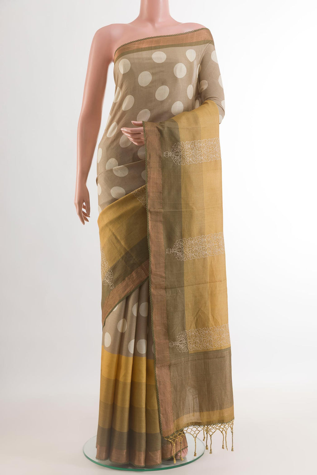 Grey Tussar Silk Saree with Printed design on the body and Embroidery Border.  displayed on a mannequin