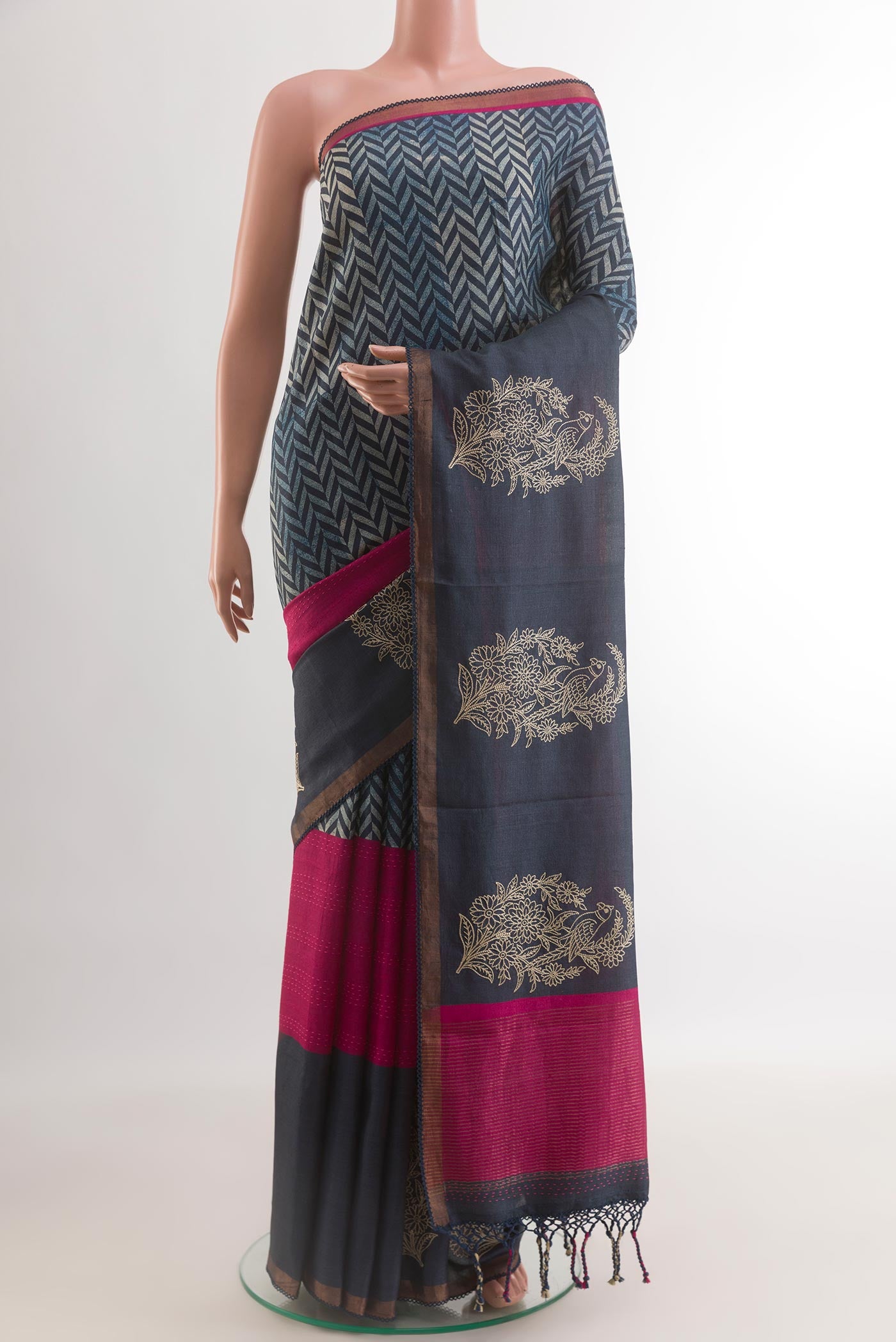 Navy Blue Tussar Silk Saree with Printed design on the body and Zari Border.  displayed on a mannequin
