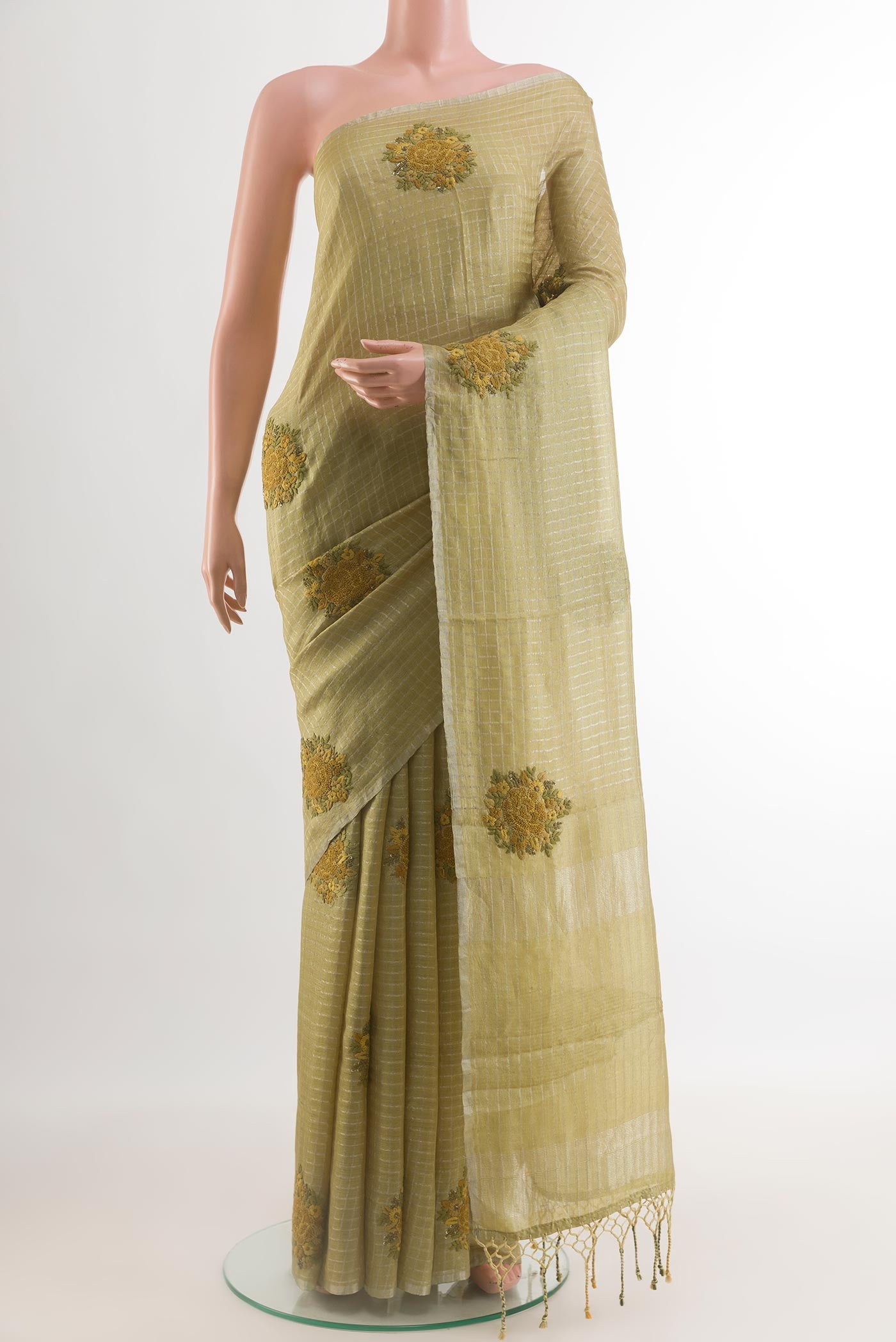 Green Tussar Silk Saree with Checked design on the body and Embroidery Border.  displayed on a mannequin