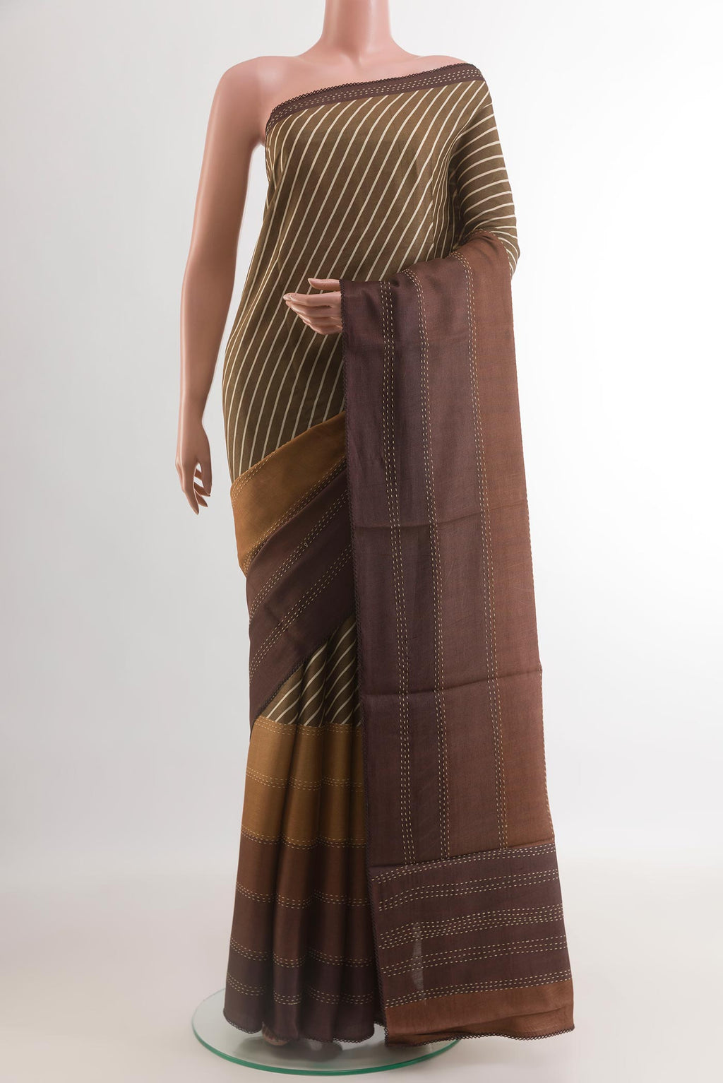 Brown Tussar Silk Saree with Printed design on the body and Zari Border.  displayed on a mannequin