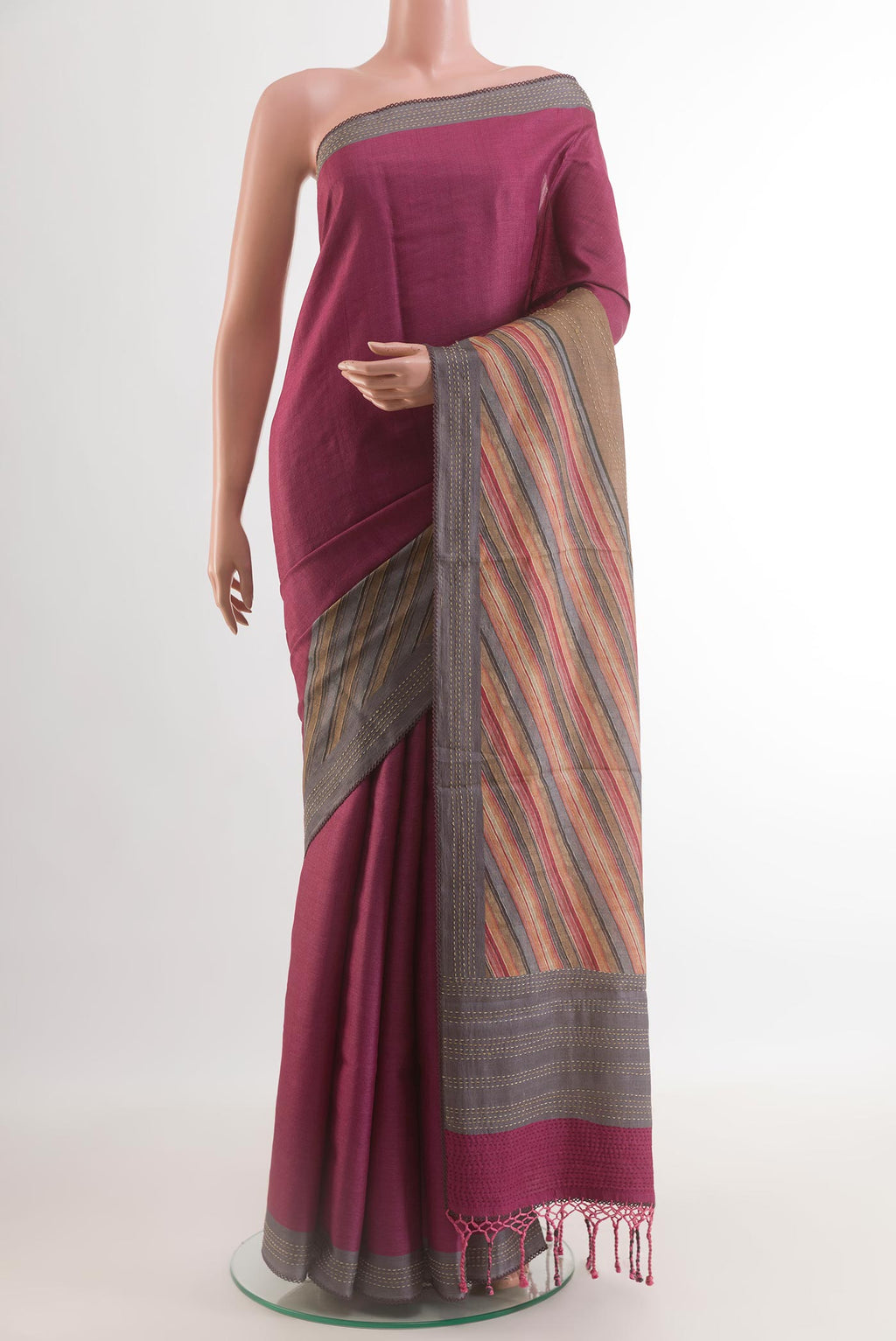 Magenta Tussar Silk Saree with Plain Body and Zari Border.  displayed on a mannequin