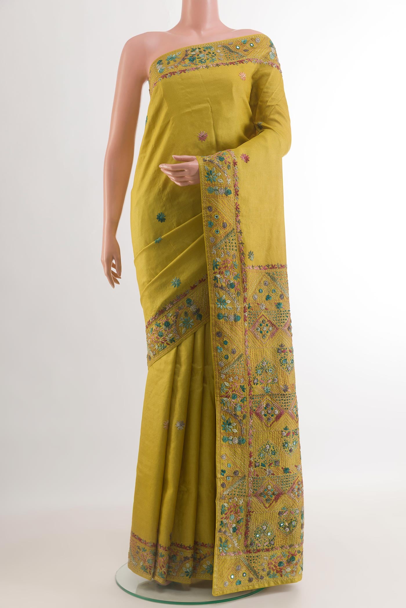 Green Tussar Silk Saree with Embroidery on the body and Embroidery Border.  displayed on a mannequin