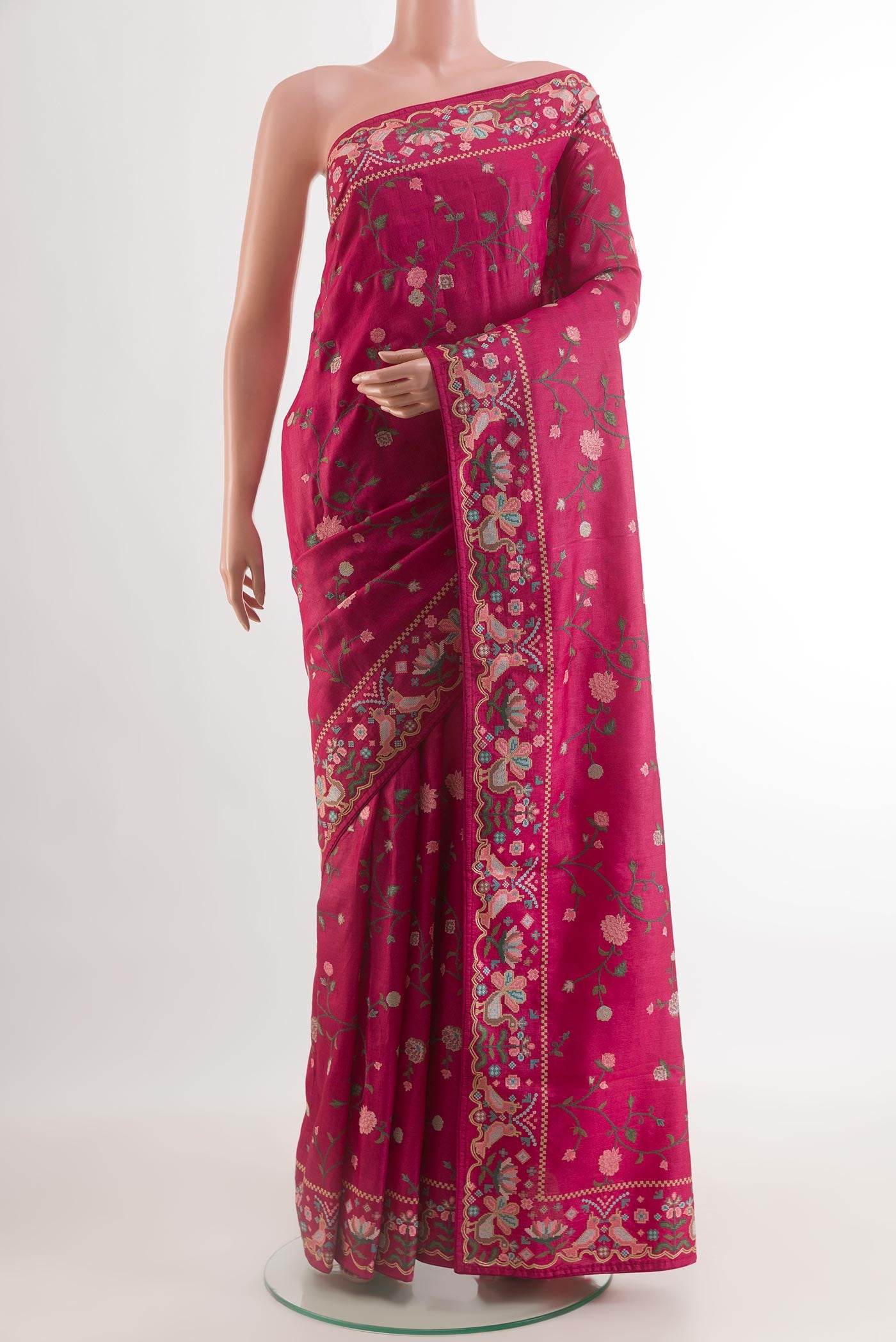 Magenta Tussar Silk Saree with Embroidery on the body and Embroidery Border.  displayed on a mannequin
