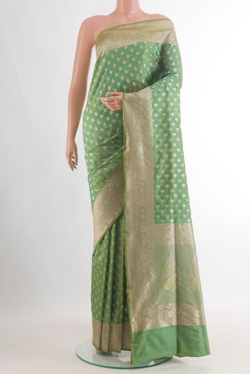 Pure Silk Light Green Banarasi Saree with Zari Butta on the body and Zari Border.  displayed on a mannequin