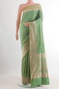 Pure Silk Light Green Banarasi Saree with Zari Butta on the body and Zari Border.  displayed on a mannequin