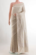 Off White Banarasi Silk Saree with Zari Butta on the body and Zari Border.  displayed on a mannequin