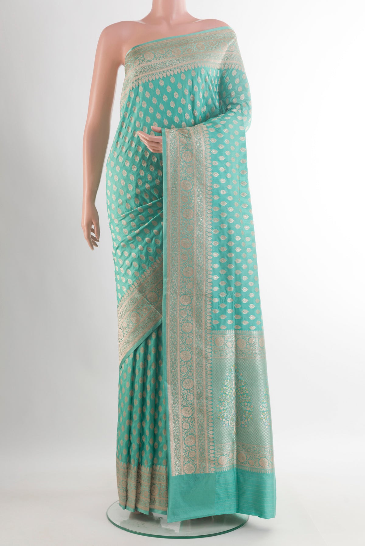 Pure Silk Sea Green Banarasi Saree with Zari Butta on the body and Zari Border.  displayed on a mannequin
