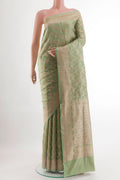 Green Banarasi Silk Saree with Zari Brocade on the body and Zari Border.  displayed on a mannequin