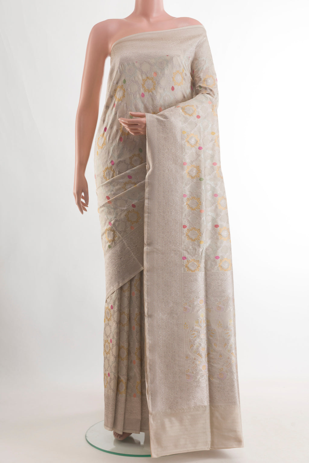 Cream Banarasi Silk Saree with Zari And Thread Butta on the body and Zari Border.  displayed on a mannequin