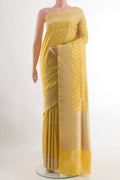 Mustard Banarasi Silk Saree with Zari Butta on the body and Zari Border.  displayed on a mannequin