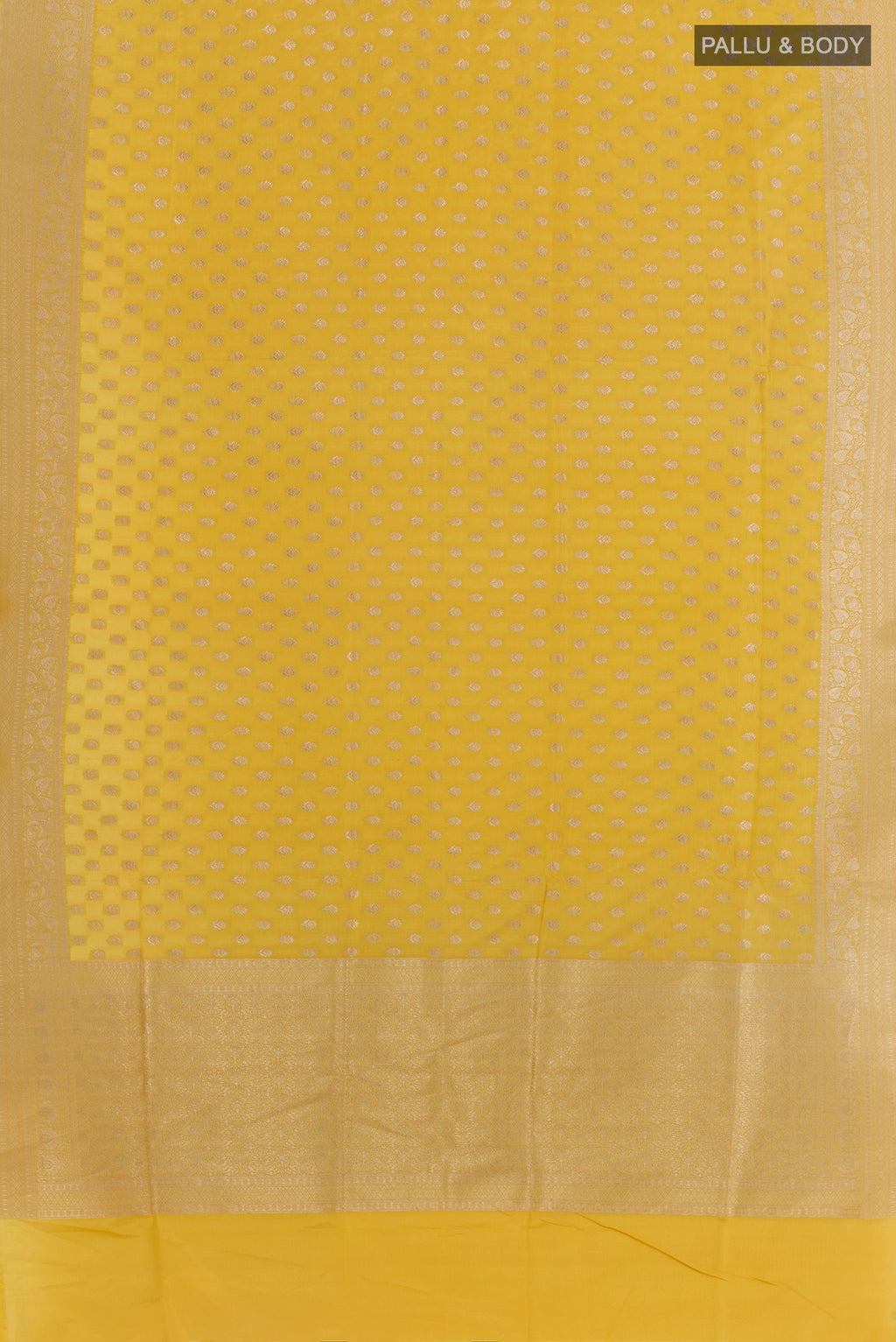 Flat view of Mustard Banarasi Silk Saree with Zari Butta on the body and Zari Border. 