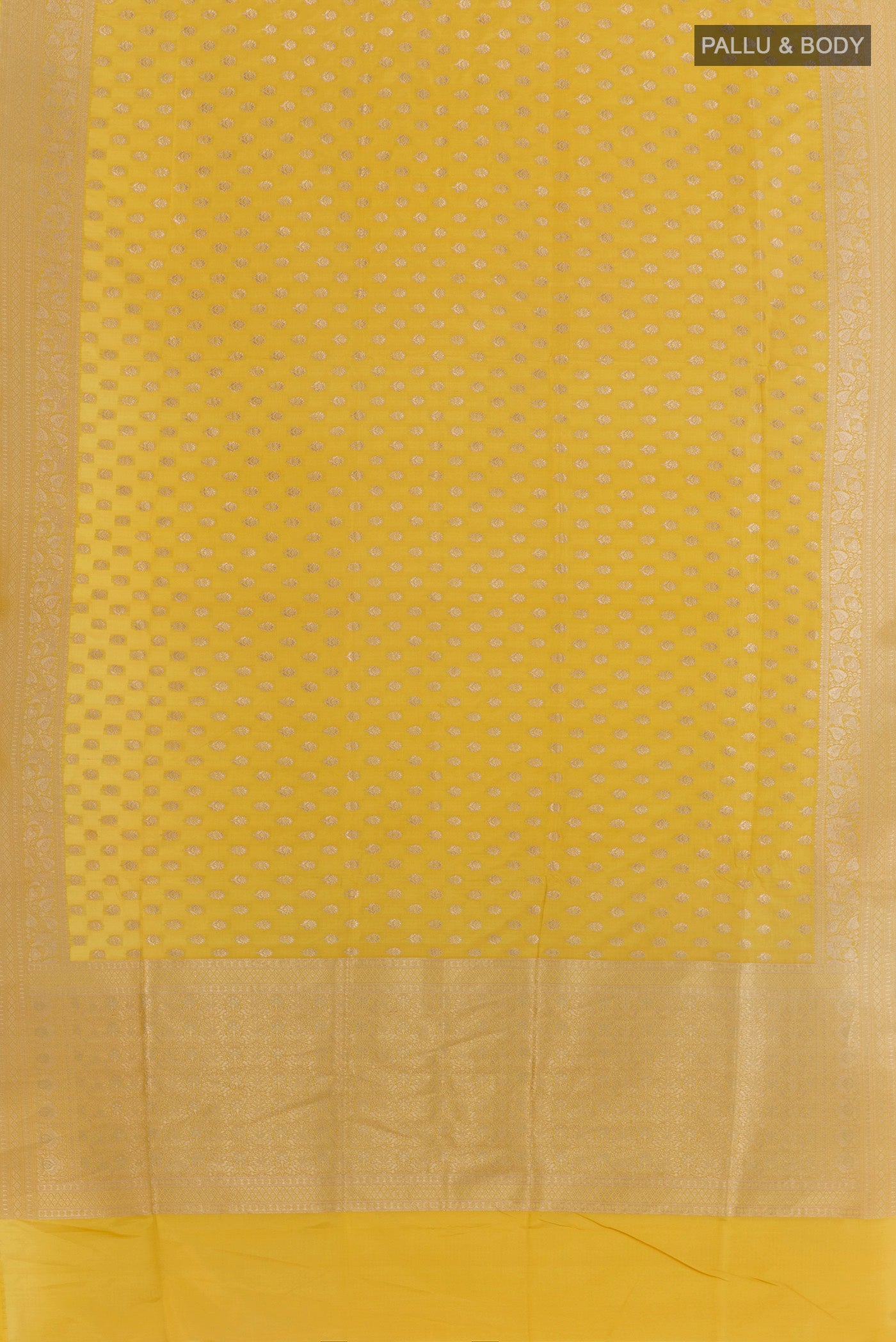 Flat view of Mustard Banarasi Silk Saree with Zari Butta on the body and Zari Border. 