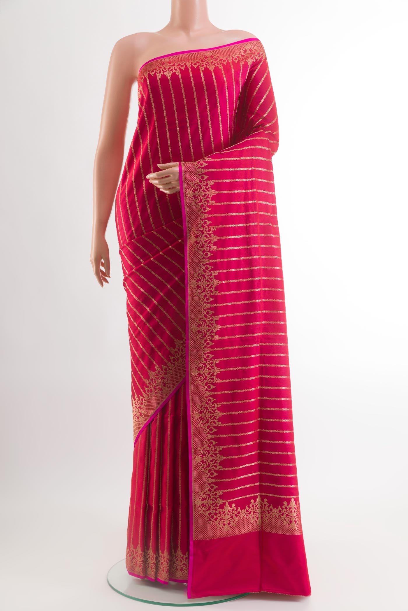 Dark Pink Banarasi Silk Saree with Stripes on the body and Zari Border.  displayed on a mannequin