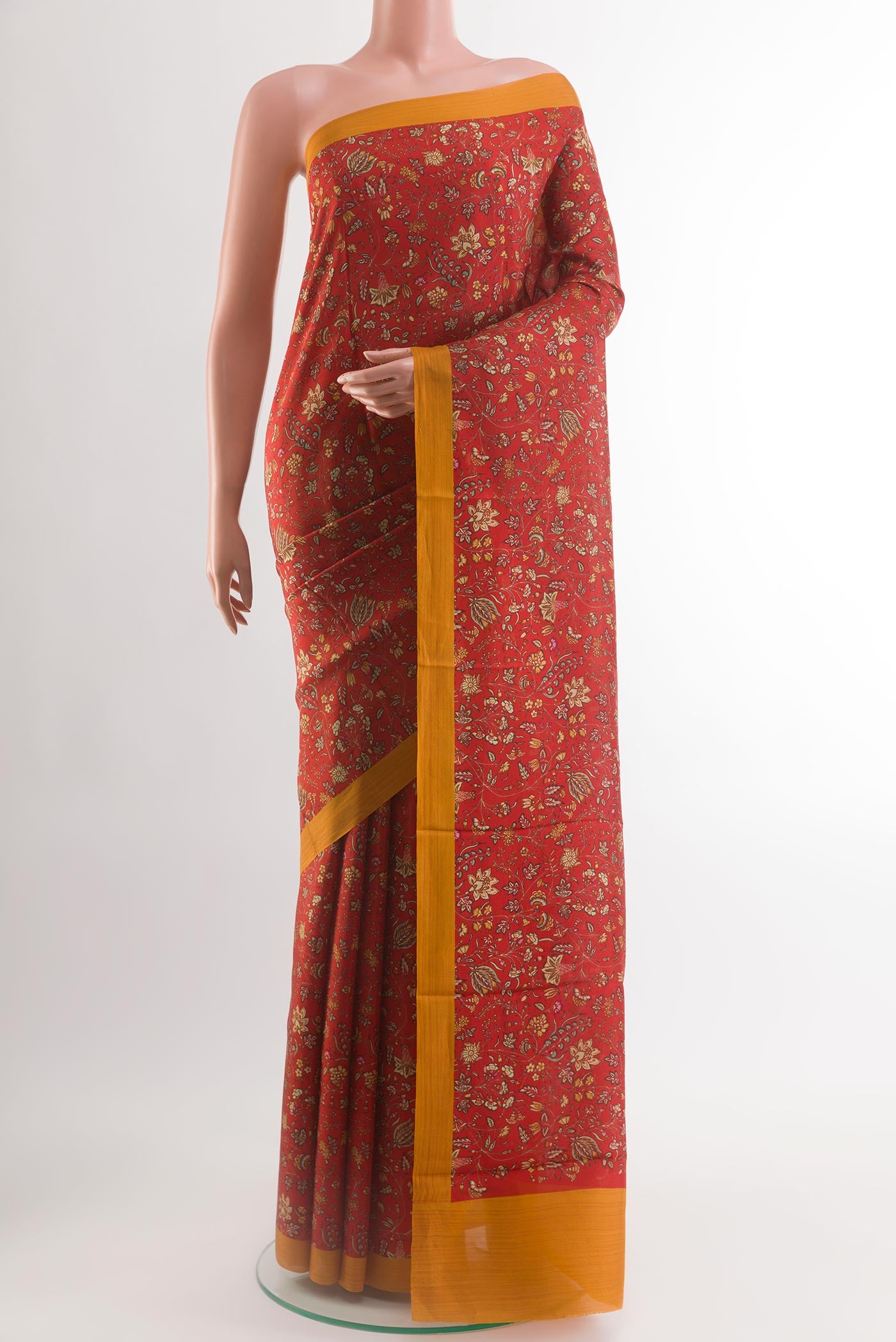 Red Printed Silk Saree with Printed design on the body and Plain Border.  displayed on a mannequin
