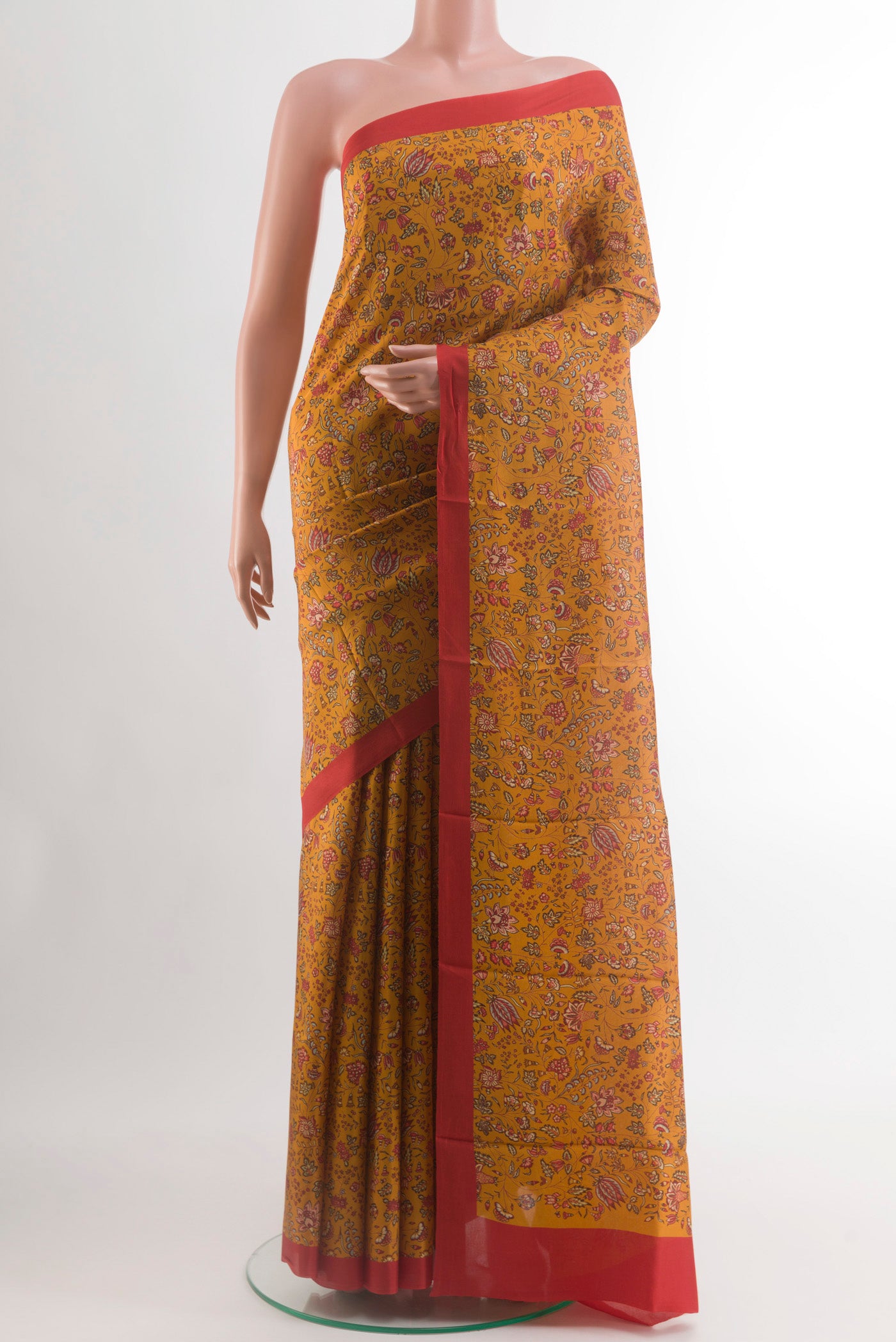 Mustard Printed Silk Saree with Printed design on the body and Printed Border.  displayed on a mannequin