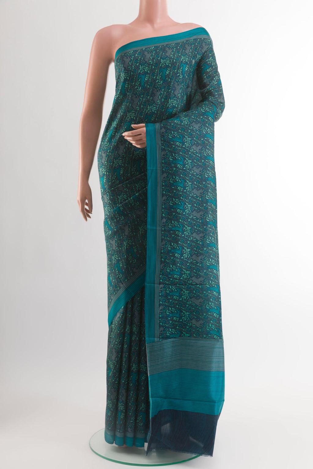 Dark Blue Printed Silk Saree with Printed design on the body and Plain Border.  displayed on a mannequin