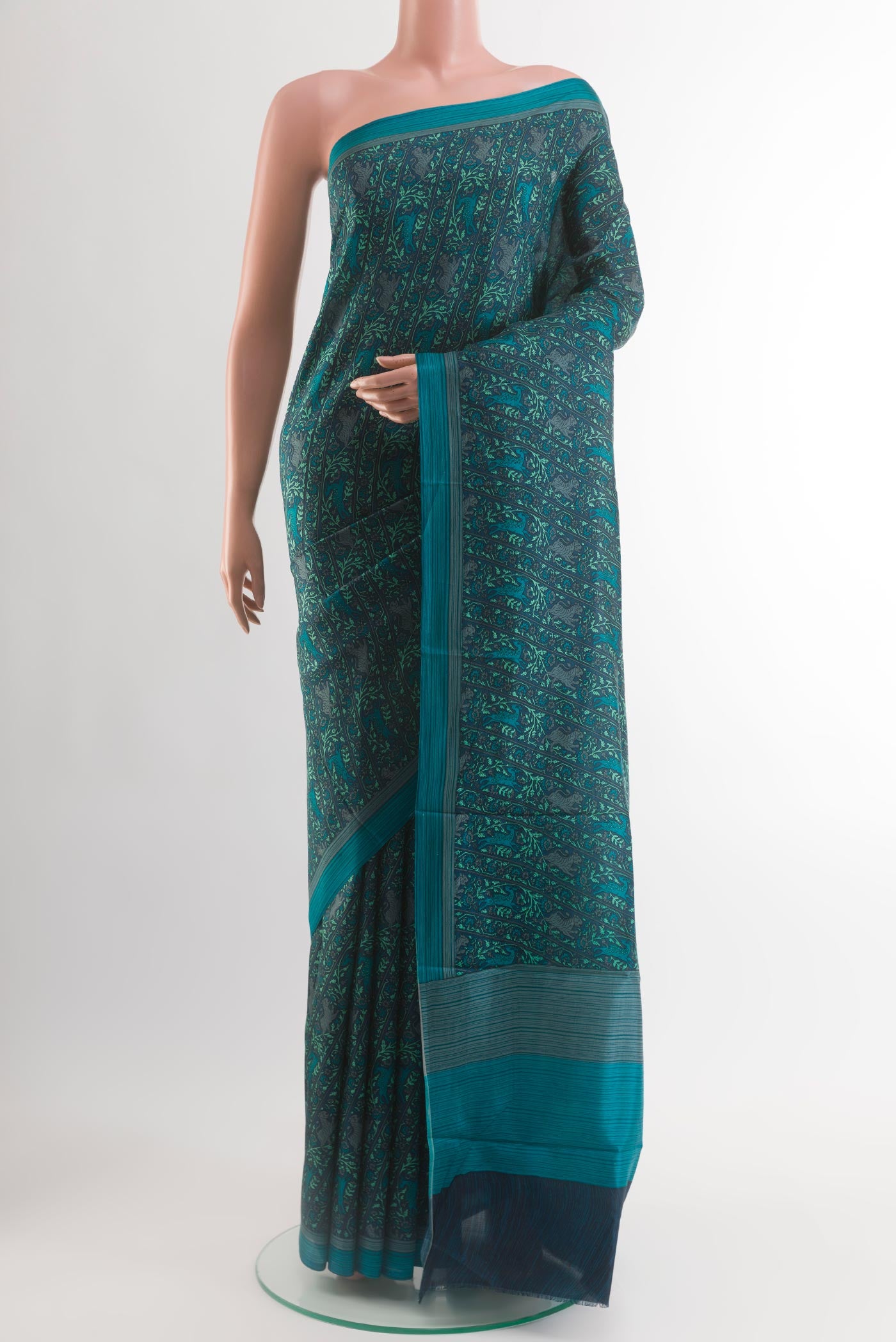 Dark Blue Printed Silk Saree with Printed design on the body and Plain Border.  displayed on a mannequin