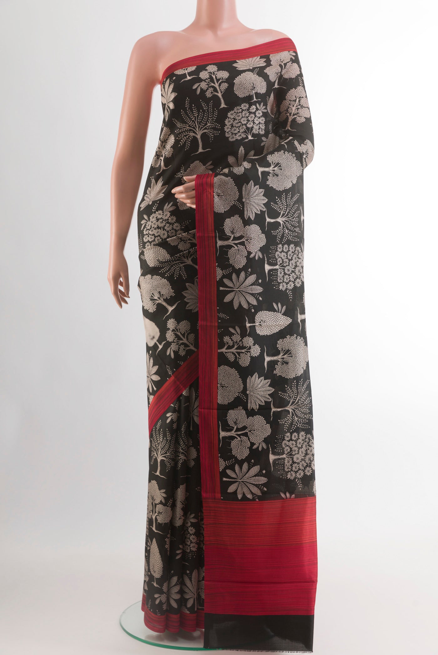 Black Printed Silk Saree with Floral Print on the body and Plain Border.  displayed on a mannequin