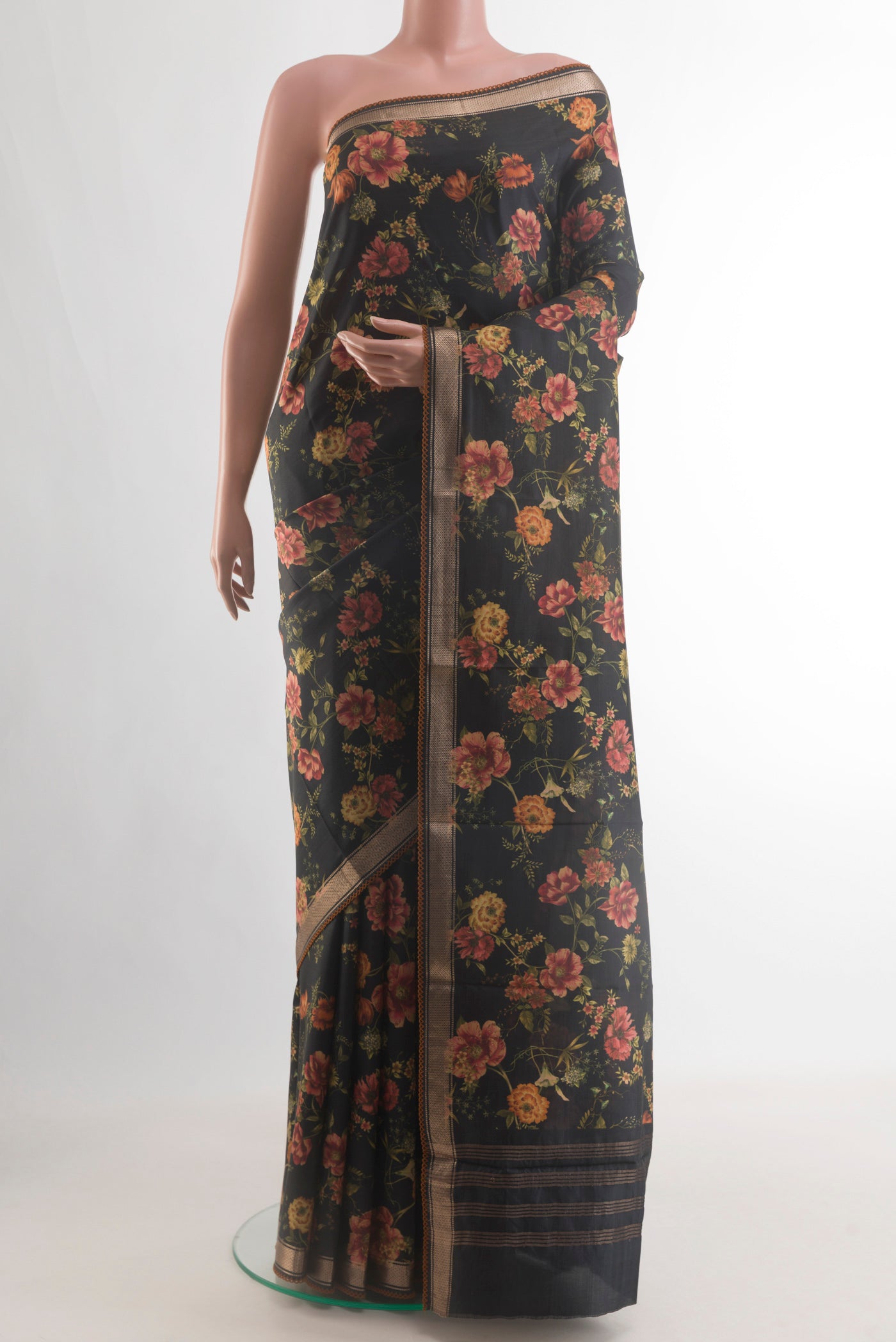 Black Printed Silk Saree with Floral Print on the body and Zari Border.  displayed on a mannequin