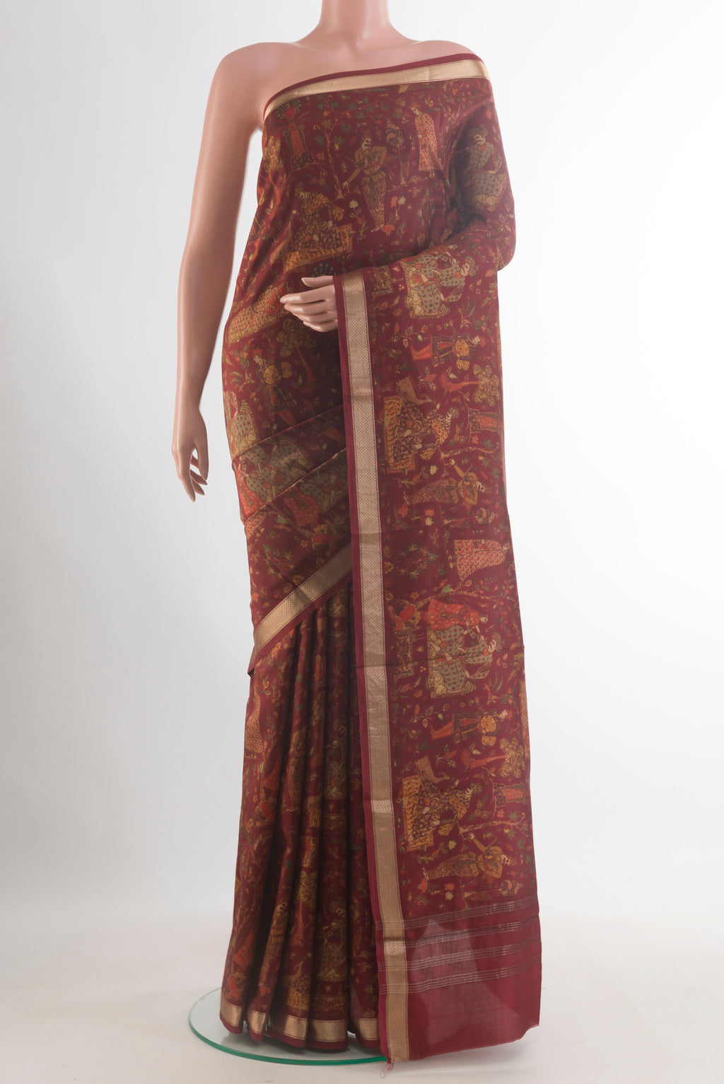 Pure Silk Maroon Printed Saree with Printed design on the body and Zari Border.  displayed on a mannequin