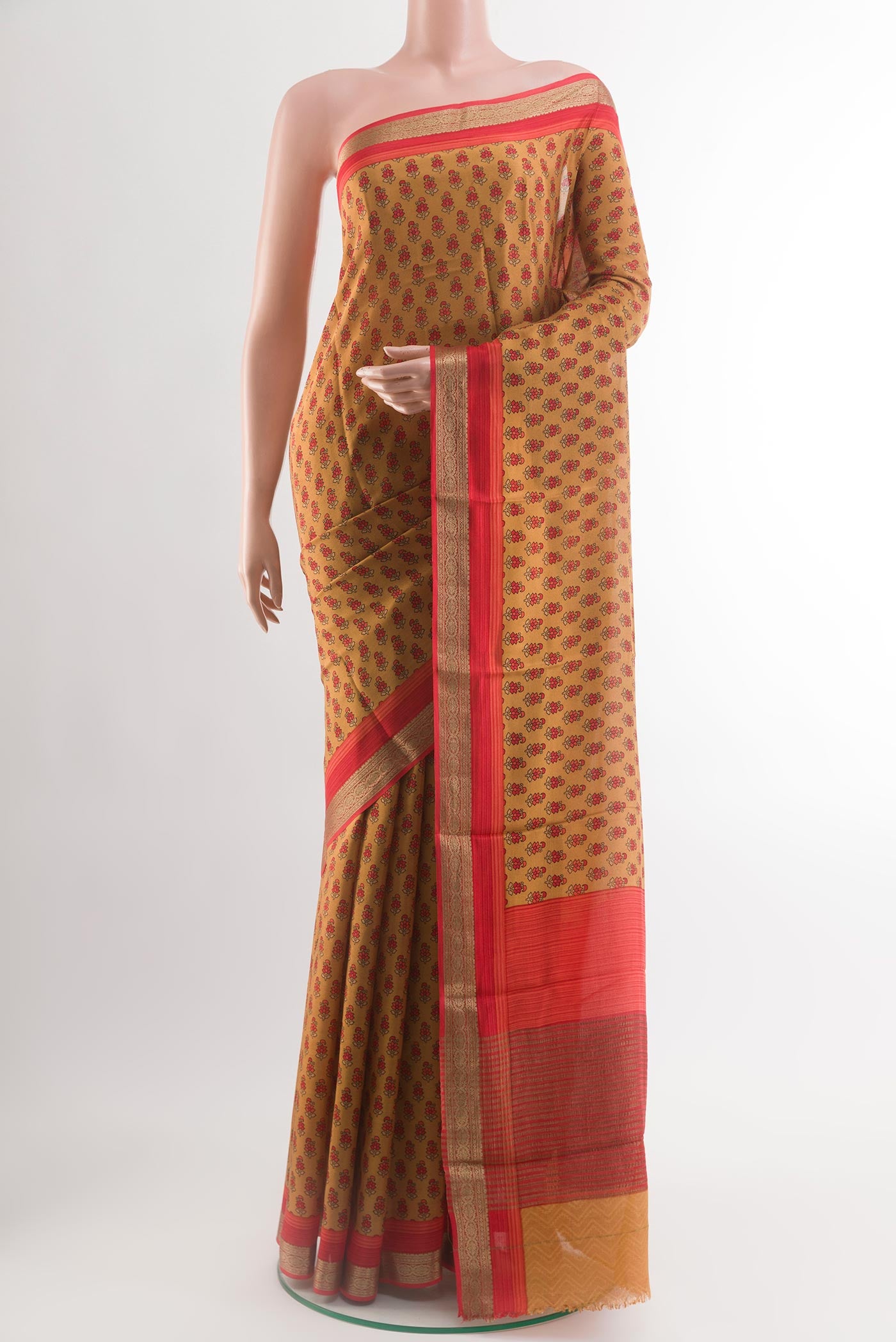 Mustard Crepe Saree with Printed design on the body and Zari Border.  displayed on a mannequin