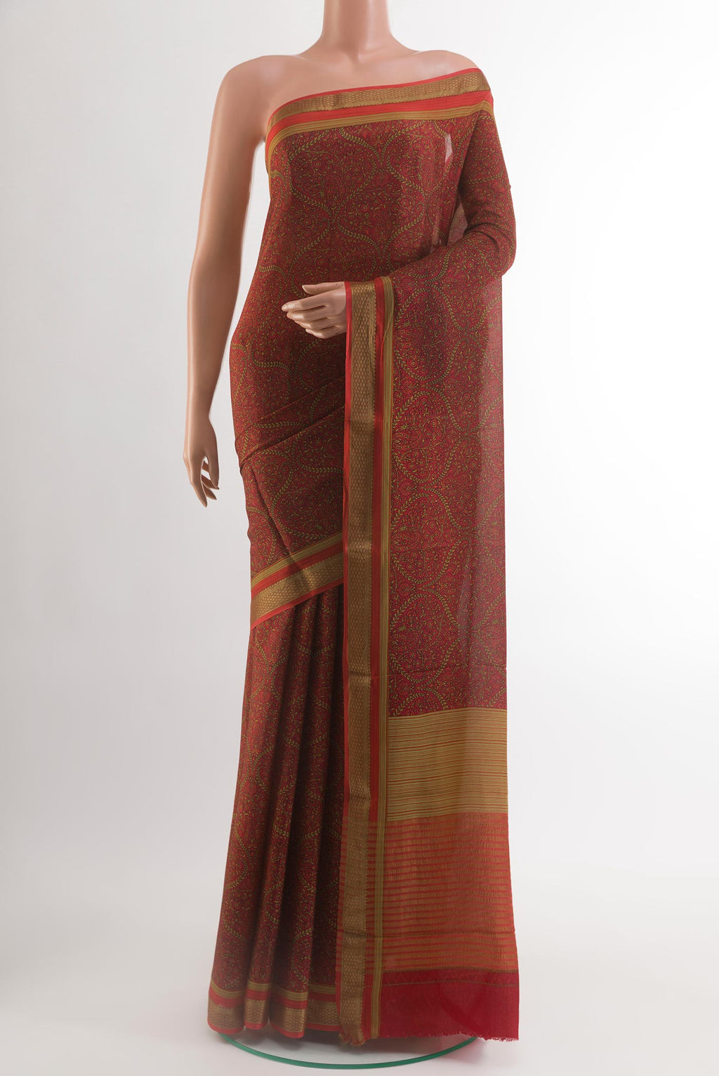 Brown Crepe Saree with Printed design on the body and Zari Border.  displayed on a mannequin