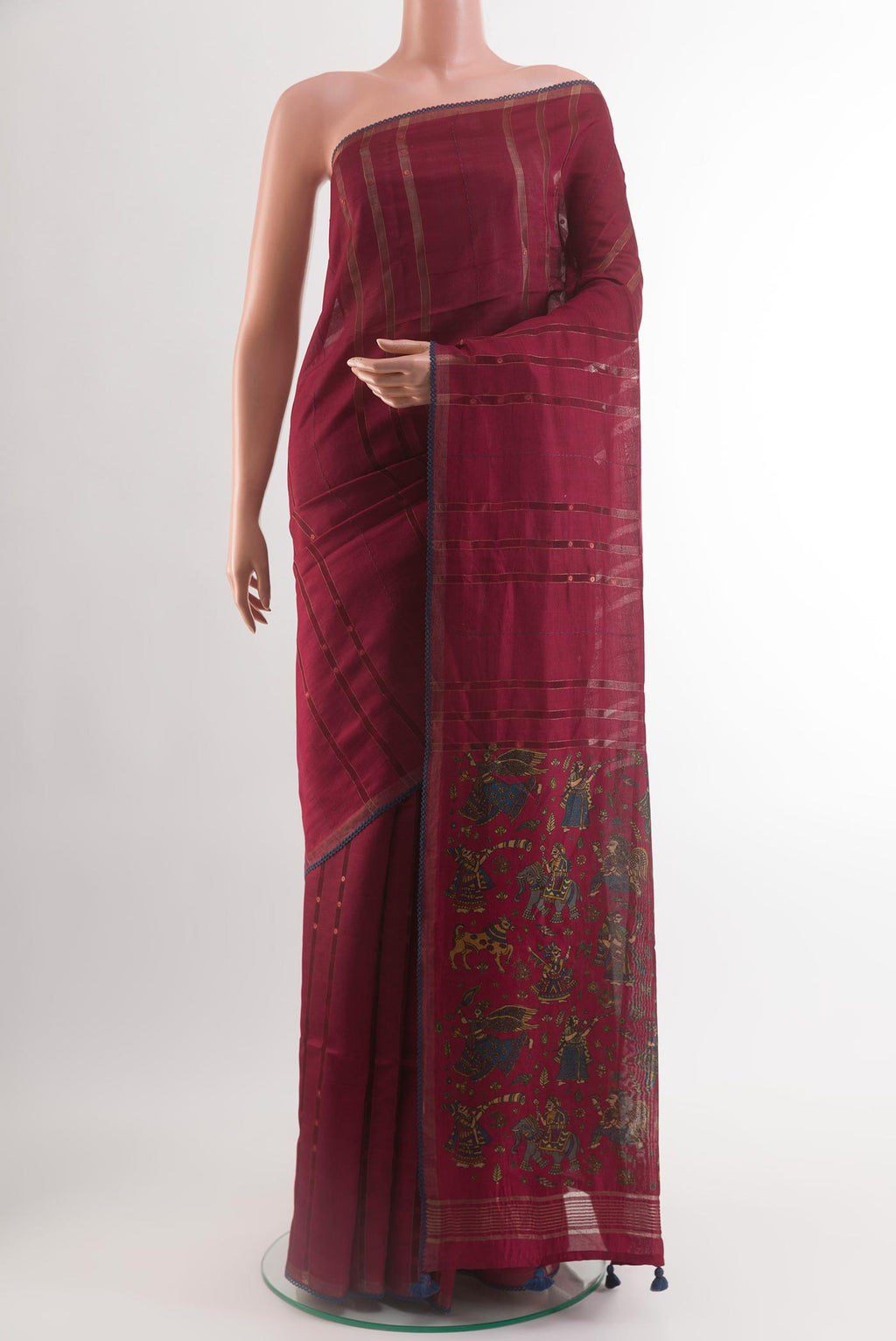 Maroon Tussar Silk Saree with Stripes on the body and Zari Border.  displayed on a mannequin