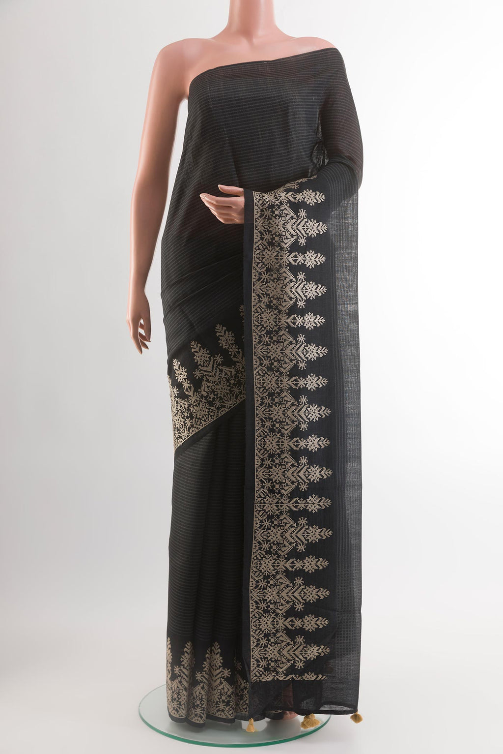 Black Tussar Silk Saree with Printed design on the body and Embroidery Border.  displayed on a mannequin