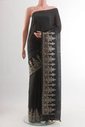 Black Tussar Silk Saree with Printed design on the body and Embroidery Border.  displayed on a mannequin