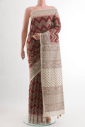 Maroon Tussar Silk Saree with Zig Zag design on the body and Embroidery Border.  displayed on a mannequin