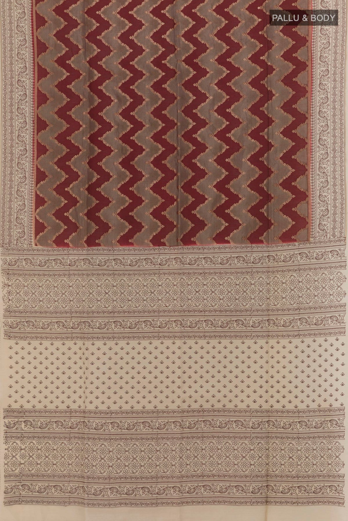 Flat view of Maroon Tussar Silk Saree with Zig Zag design on the body and Embroidery Border. 