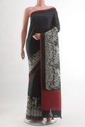 Black Tussar Silk Saree with Plain Body and Embroidery Border.  displayed on a mannequin