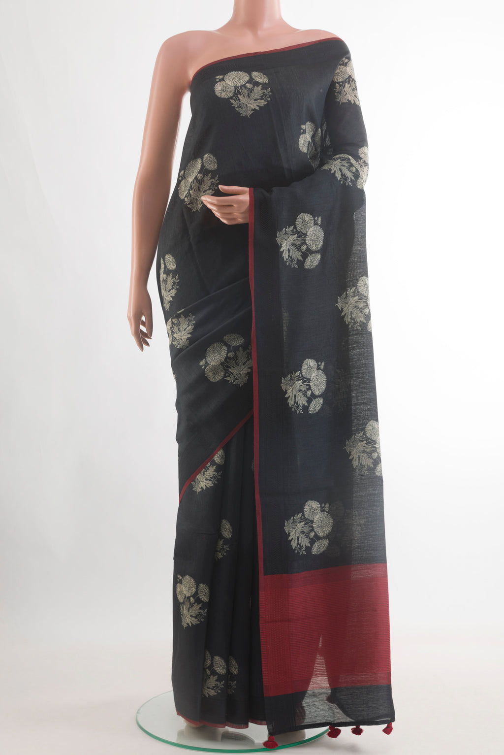 Black Tussar Silk Saree with Printed design on the body and Without Border.  displayed on a mannequin
